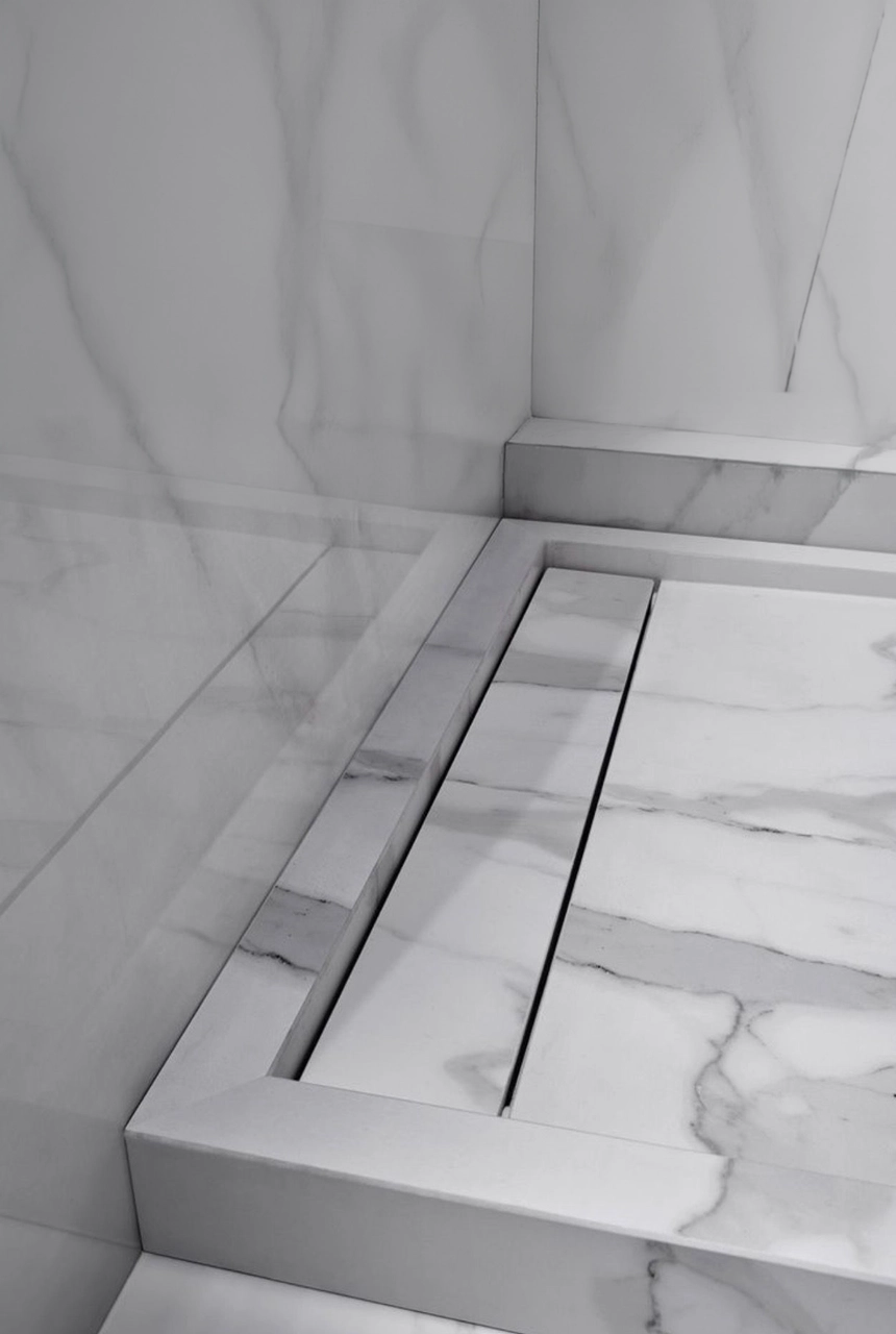 X4 Design and Build white marble shower floor with concealed linear drain, marble step detail, clean grout alignment, and luxury bathroom finishing