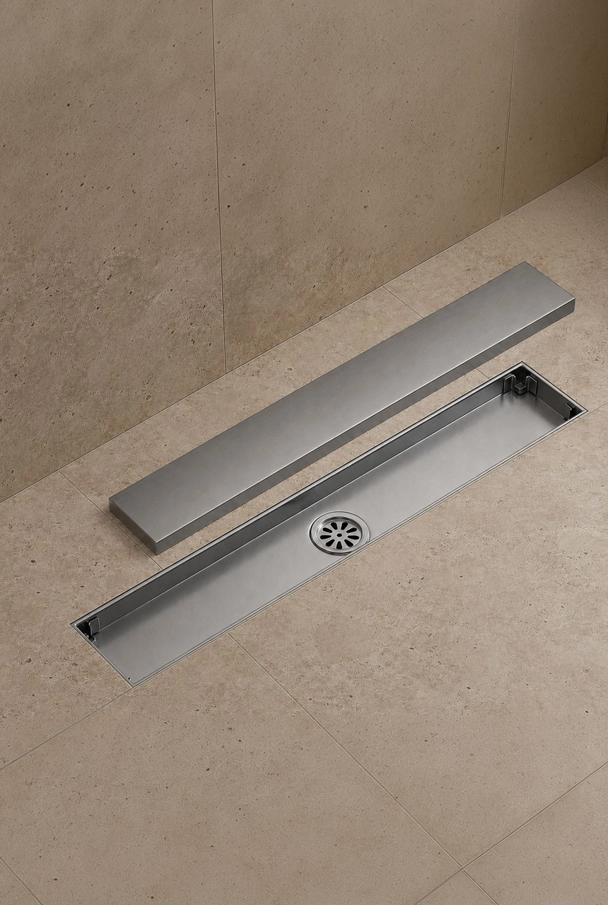 X4 Design and Build travertine bathroom floor with stainless steel linear floor trap, removable cover, drainage channel, and modern shower detail